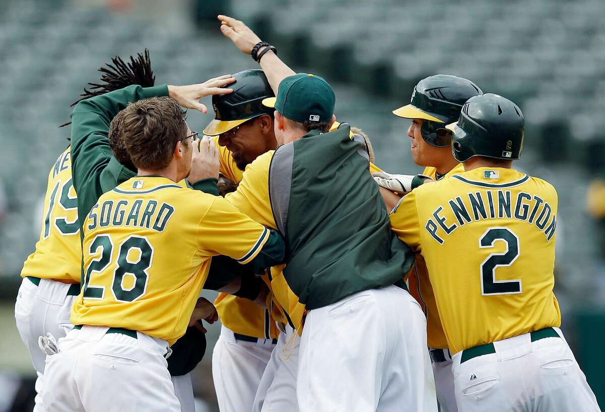 Oakland Athletics' Yoenis Cespedes high-fives Oakland Athletics