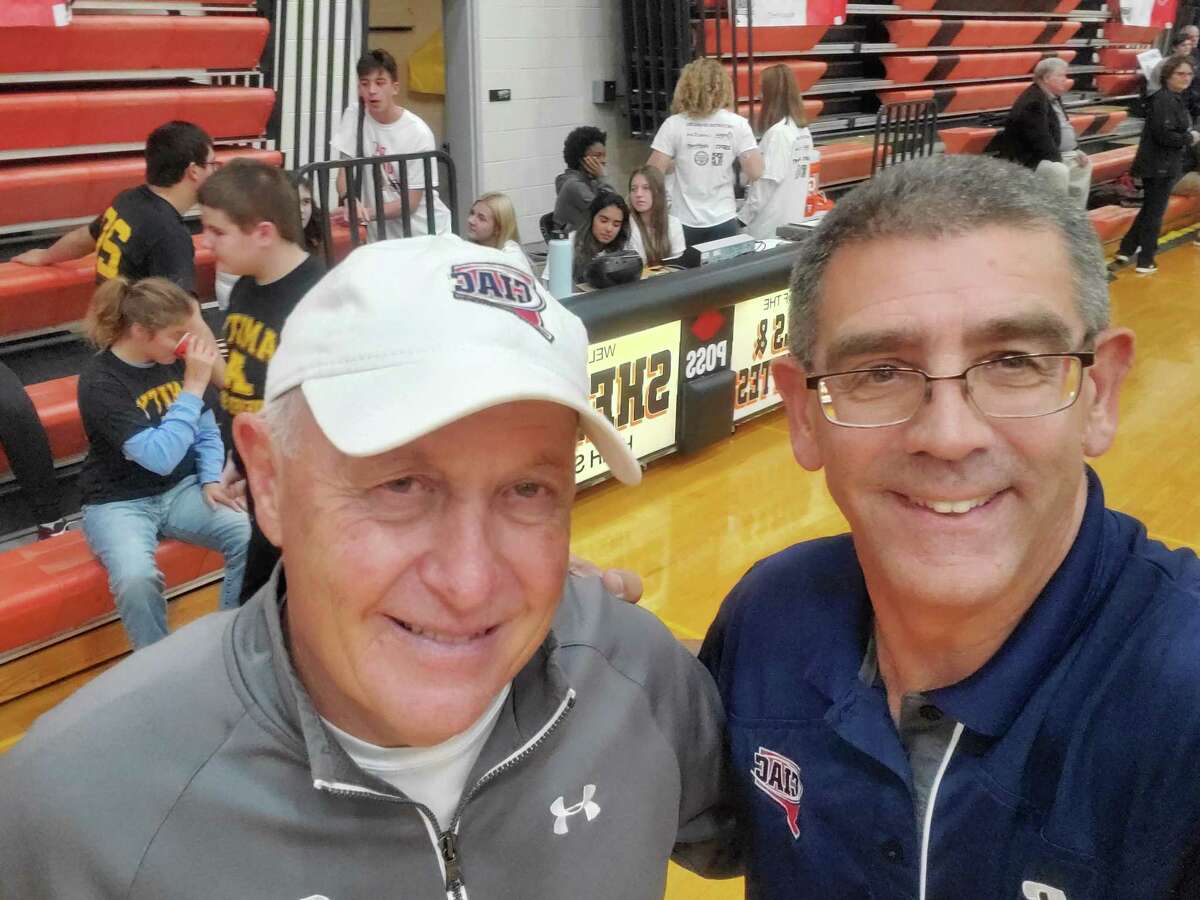 John Niski at right stands with CIAC Assistant Director of Unified Sports Paul Mengold at a Unified Sports basketball game.