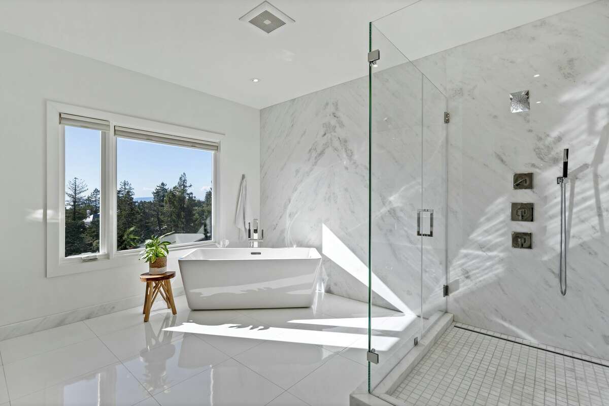 The master bath features a bathtub overlooking the city.