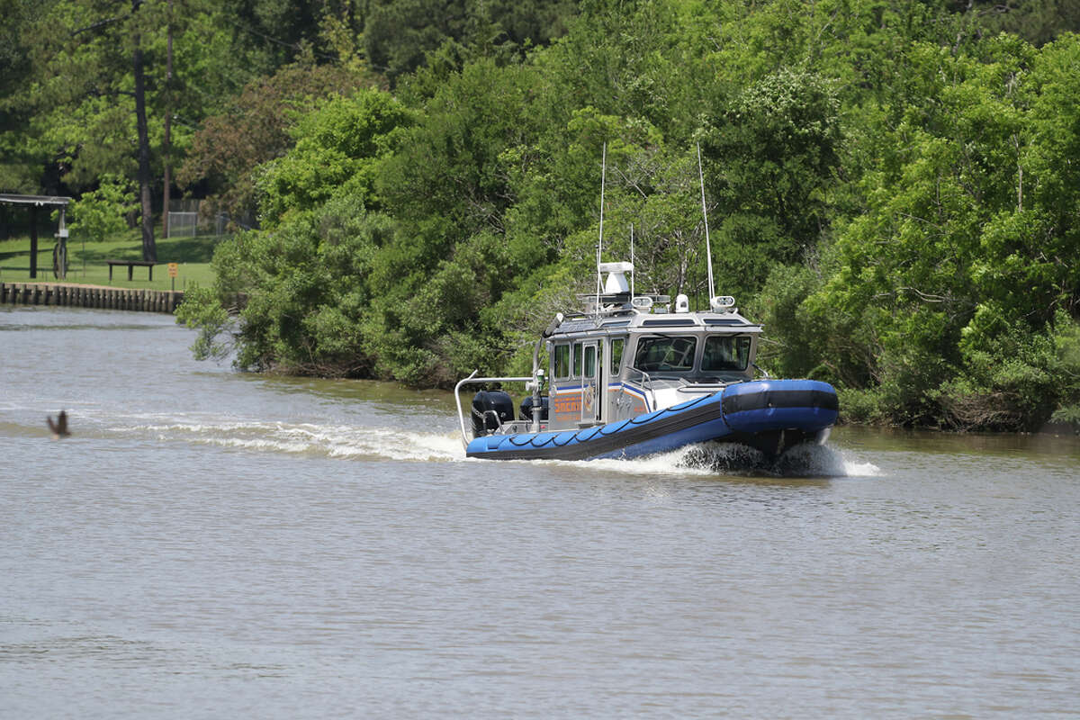 A Harris County Sheriff's boat heads downstream while the Coast Guard is searching for seven possible people in the water in Cedar Bayou just west of the U.S. Highway 146 bridge Tuesday, April 21, 2020, in Baytown.