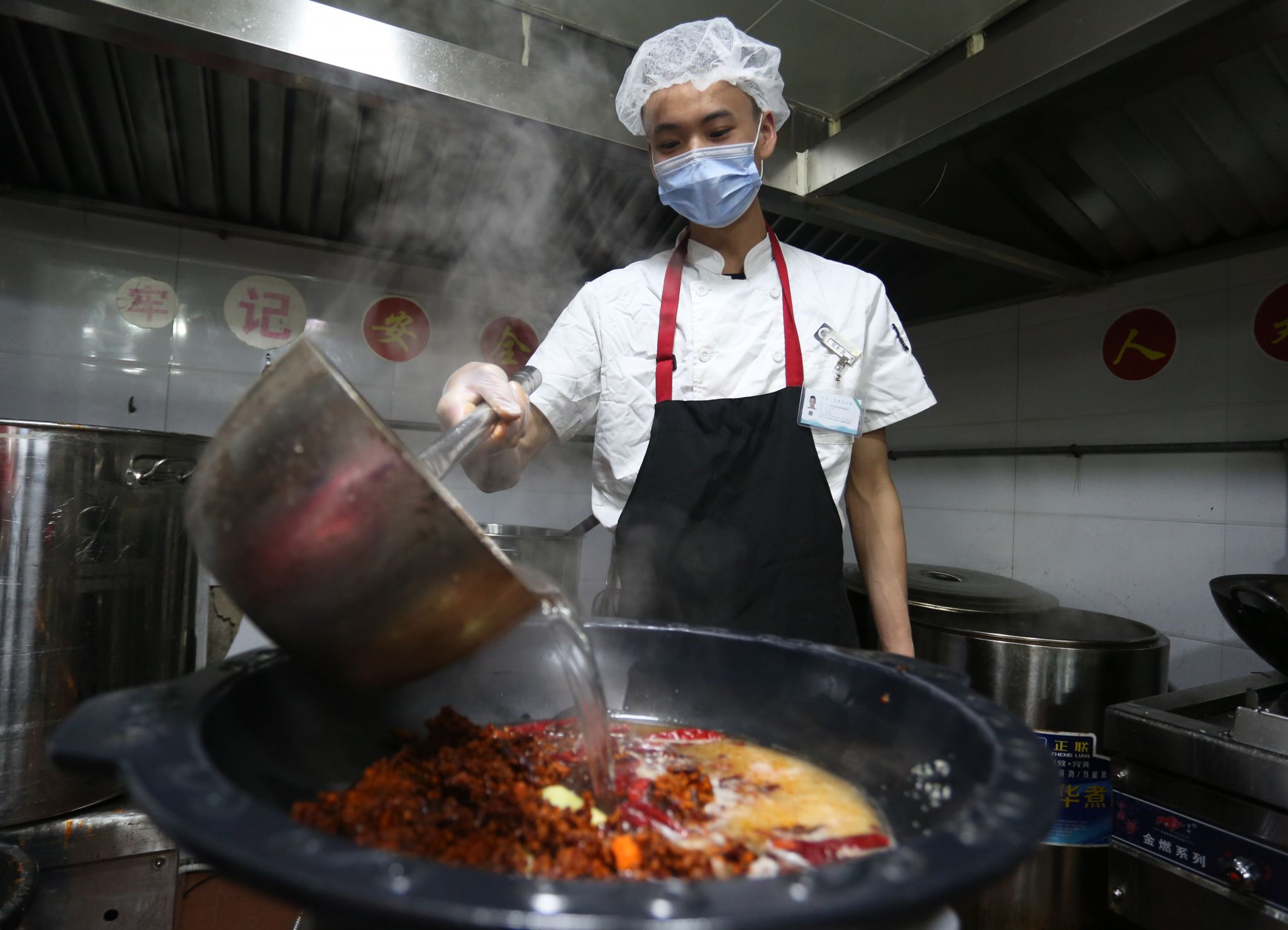 Workers prepare the hot-pot bottom in Guiyang, Guizhou, China, on March 26, 2020.