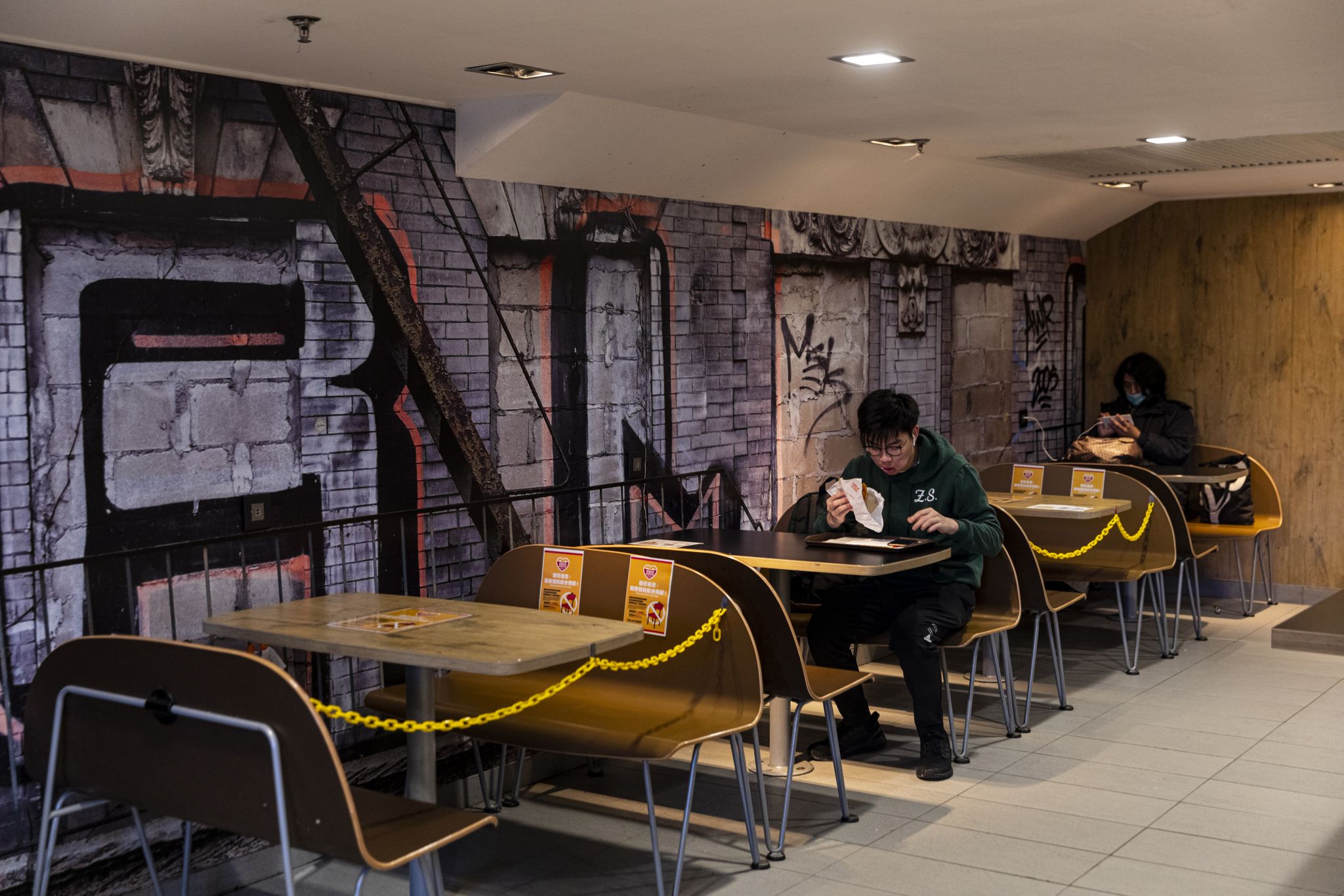 Customers are seated at a social distance in a restaurant during the coronavirus pandemic on April 3, 2020. The Hong Kong government has imposed new restrictions in form of a social-distance law as a preventive measure against the spread of coronavirus.