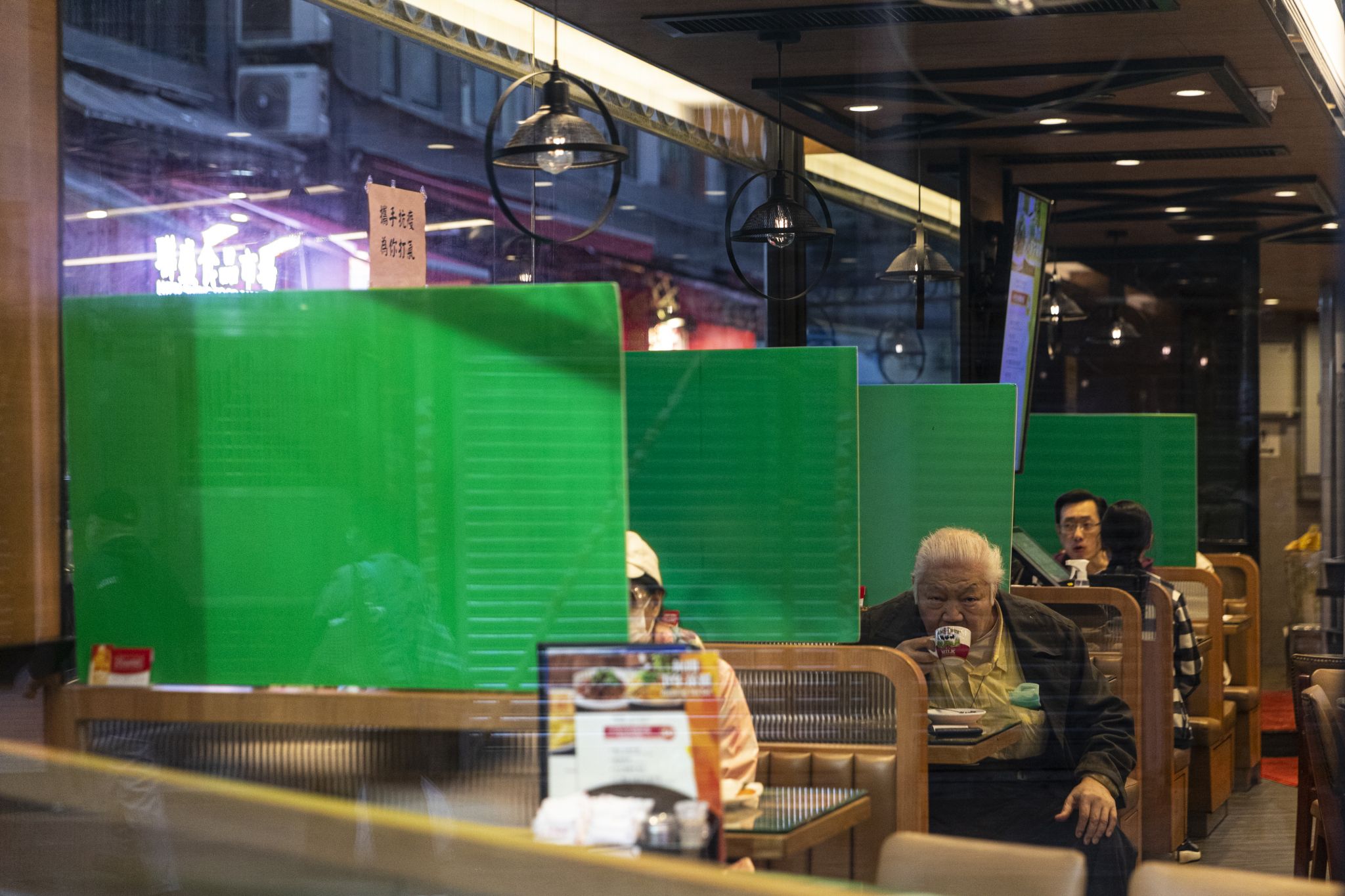 Plastic barriers enforcing social distancing are seen in a restaurant during the coronavirus pandemic on April 3, 2020. The Hong Kong government has imposed new restrictions in form of a social-distance law as a preventive measure against the spread of coronavirus.