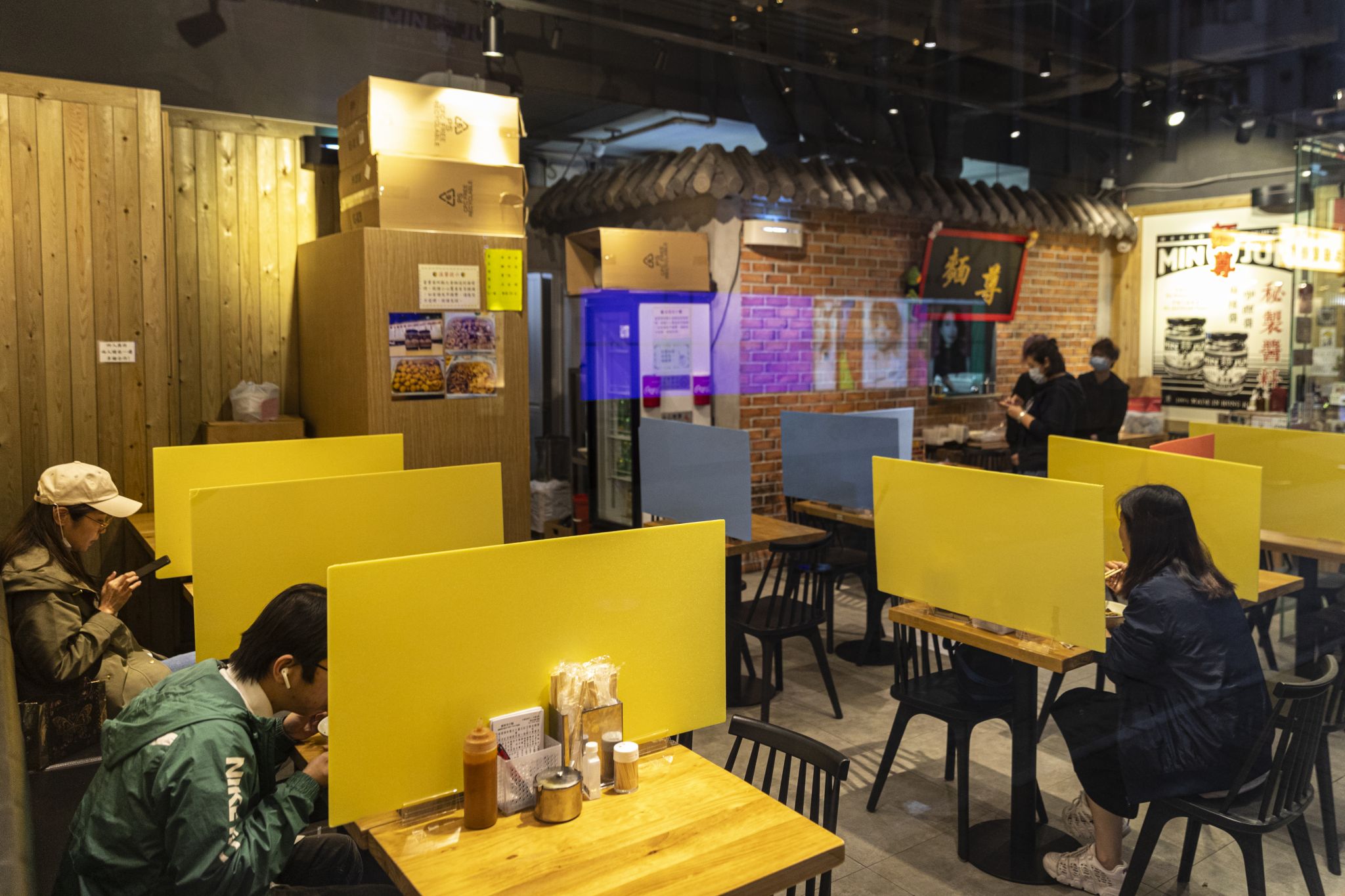 Plastic barriers enforcing social distancing are seen in a restaurant during the coronavirus pandemic on April 3, 2020.