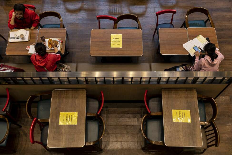 Customers are seated at a social distance in a restaurant on April 3, 2020. The Hong Kong government has imposed new restrictions in the form of a social-distance law as a preventive measure against the spread of coronavirus.