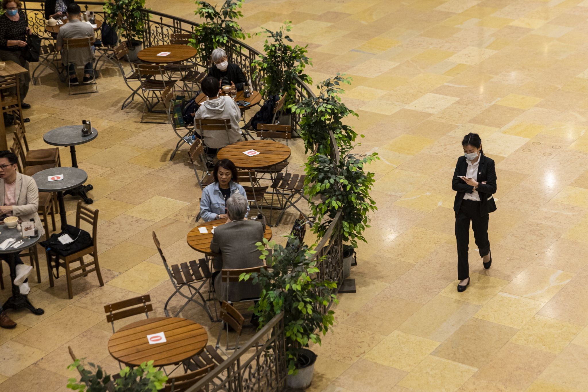Customers are seated at a social distance in a restaurant during the coronavirus pandemic on April 3, 2020. The Hong Kong government has imposed new restrictions in the form of a social-distance law as a preventive measure against the spread of coronavirus.