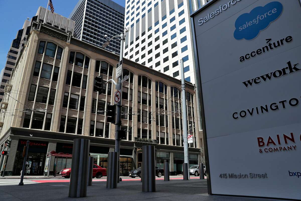A sign for Salesforce is visible in front of 440-450 Mission Street in San Francisco, Calif., on Tuesday, April 21, 2020. Salesforce purchased 440-450 Mission St. for $145 million in March, a huge sum for a relatively small building, at more than $2,500 per square foot. But location matters: The site is next to Salesforce-owned 50 Fremont and across the street from Salesforce Tower. Could a tower be built on the site? The deal may be one of the last for the 2011-2020 real estate boom, as offices have been shuttered and it?s unclear when workers will be able to return.