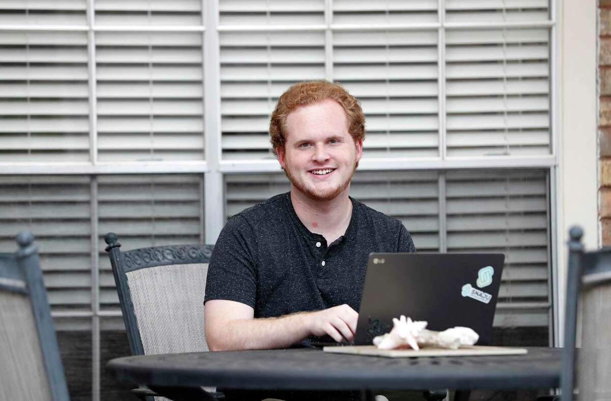 Zackary Pedersen of Snaju, works on his laptop as he is offering $25,000 worth of free websites to Houston small businesses to help them stay up and running during the coronavirus lockdown, in League City, Saturday, April 18, 2020.