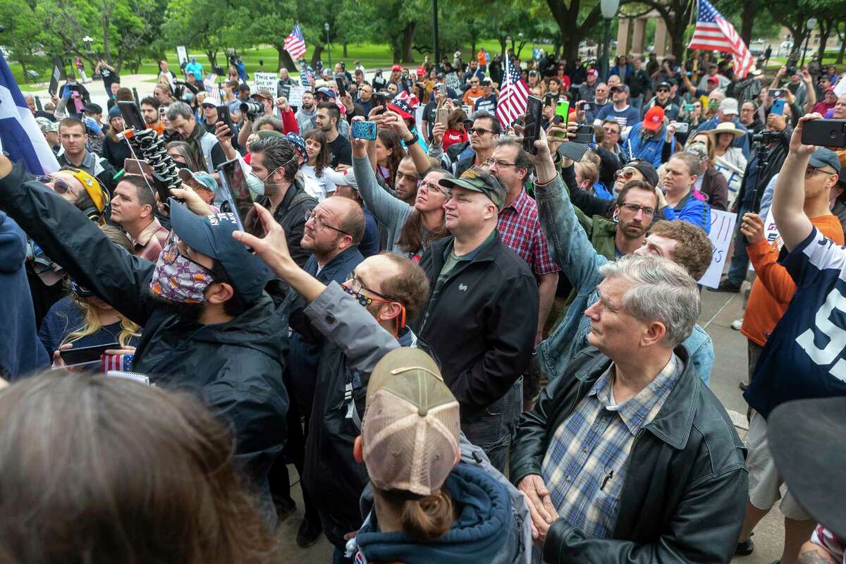 Those in attendance look to get a photo of Alex Jones while gathering at the Texas Capitol in Austin protesting the coronavirus shutdowns, Saturday, April 19, 2020.(Stephen Spillman / for Express-News)