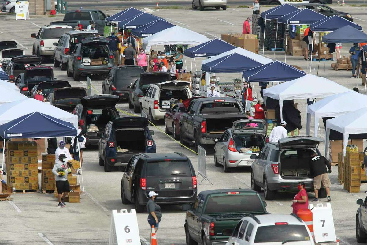 Vehicles line up at a San Antonio Food Bank distribution in April. This Thanksgiving was a time to reflect on those who need food, and those we have lost in this pandemic.