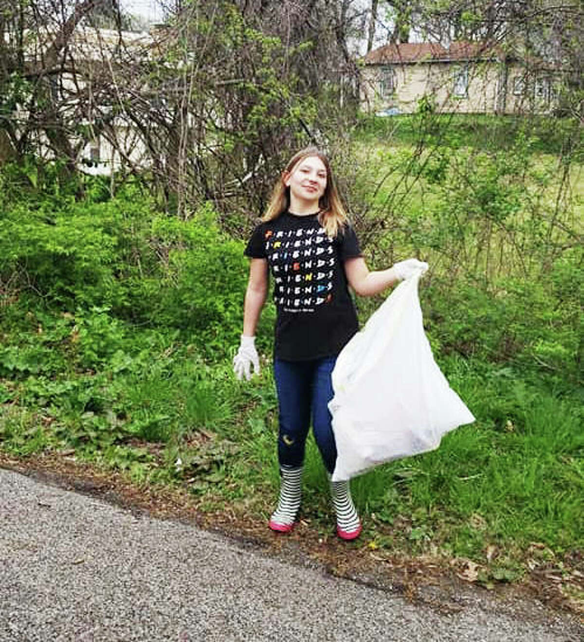 Megan Van Deusen, a founding member of the public Facebook group RiverbendTrashTagChallenge, proudly shows a bag of trash collected in Alton. The group was formed in lieu of the cancelled Alton City Wide Clean Up, originally scheduled for April 25.
