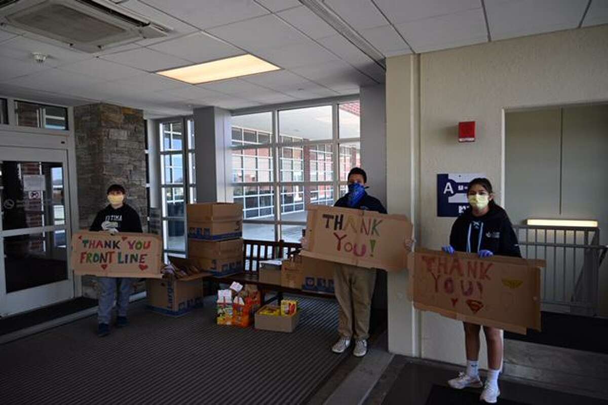 Our Lady of Fatima Catholic Academy students hold signs in April thanking hospital and other front-line workers during the COVID-19 pandemic. The school is seeking to fill a $140,000 funding gap in order to welcome students back in the fall.