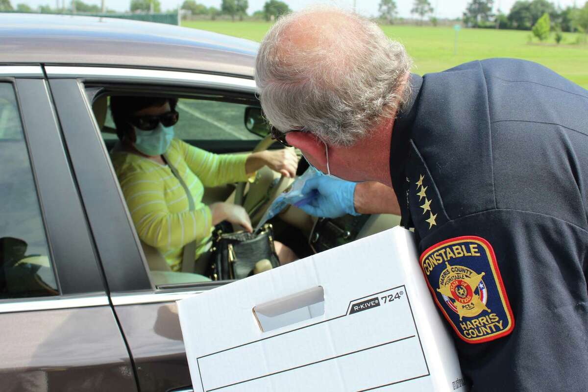 Harris County Precinct 5 Constable Ted Heap hands out bags with masks and gloves at Katy Park on Tuesday, April 21, because the 77449 zip code nearby has the highest number of COVID-19 cases in Harris County. The bags were also handed out at Bear Creek Park.