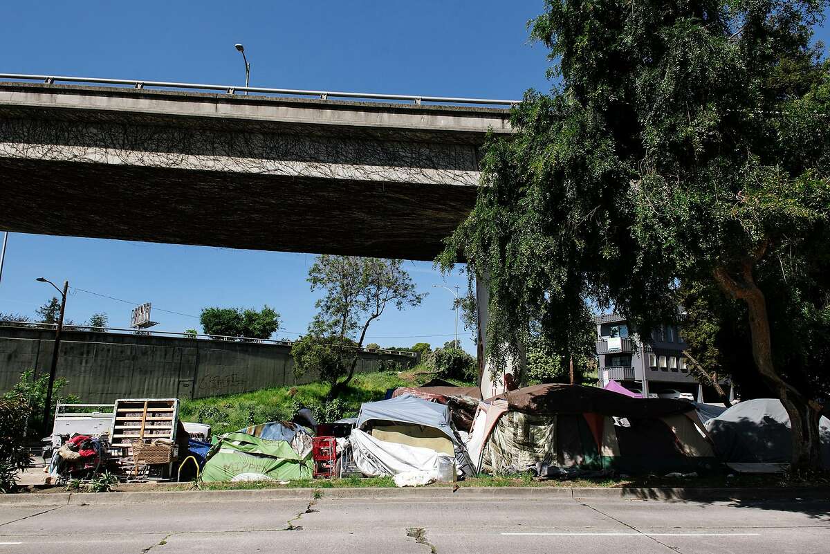 Tents and belongings are seen at a homeless encampment underneath Interstate 580 in Oakland, Calif, on Friday, April 22, 2020.