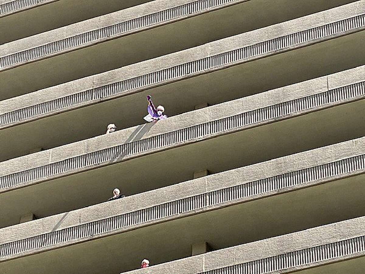 residents on the balconies at 16-story Piedmont Gardens senior complex in Oakland singing along with hootenanny Club playing in downstairs courtyard in weekly singalong