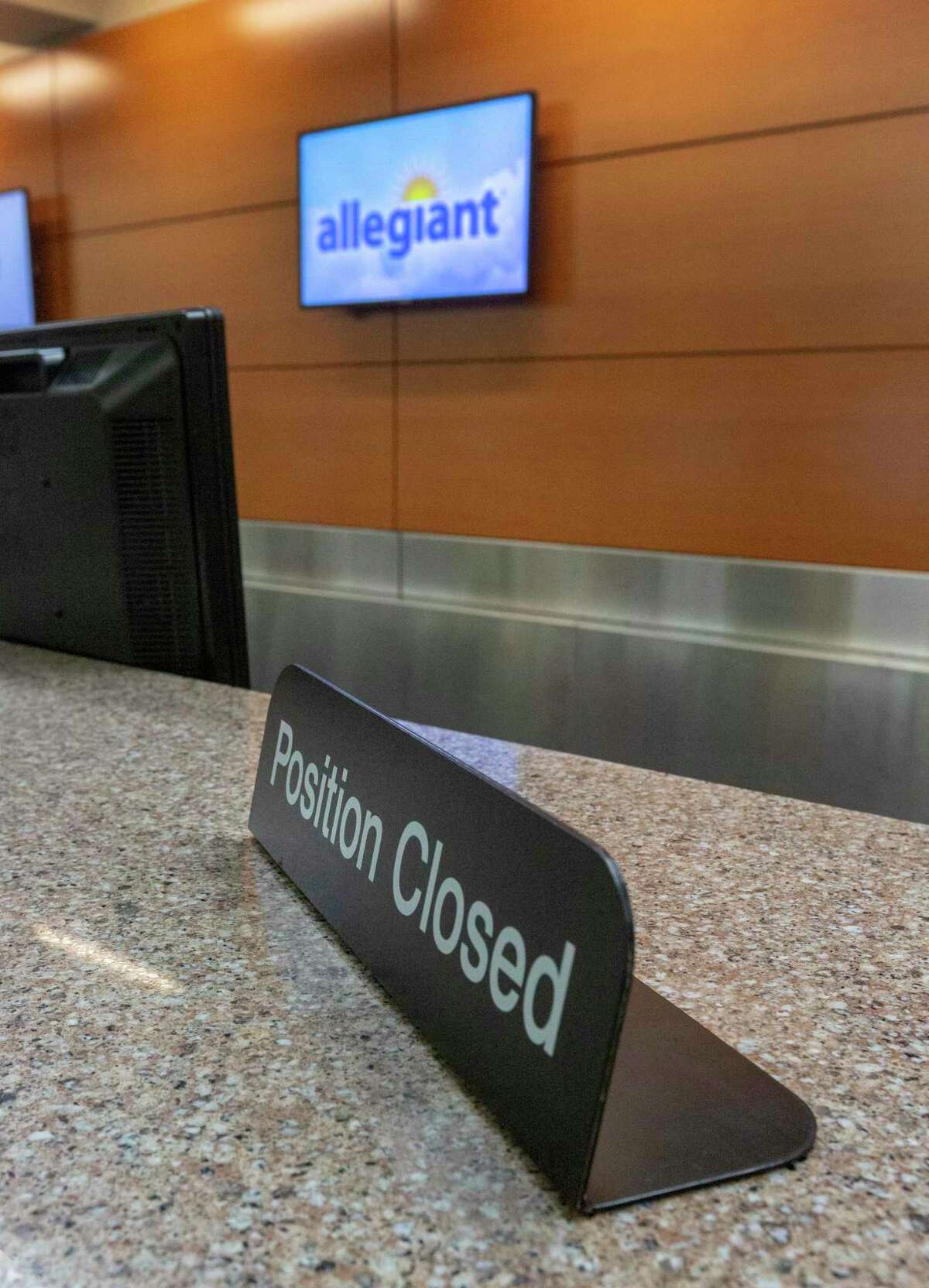 The Allegiant airline ticket counter stands empty Wednesday, April 22, 2020 at the San Antonio International Airport. Despite receiving $172 million in federal stimulus money, Allegiant is asking for a waiver from the government to allow it to cut San Antonio service.