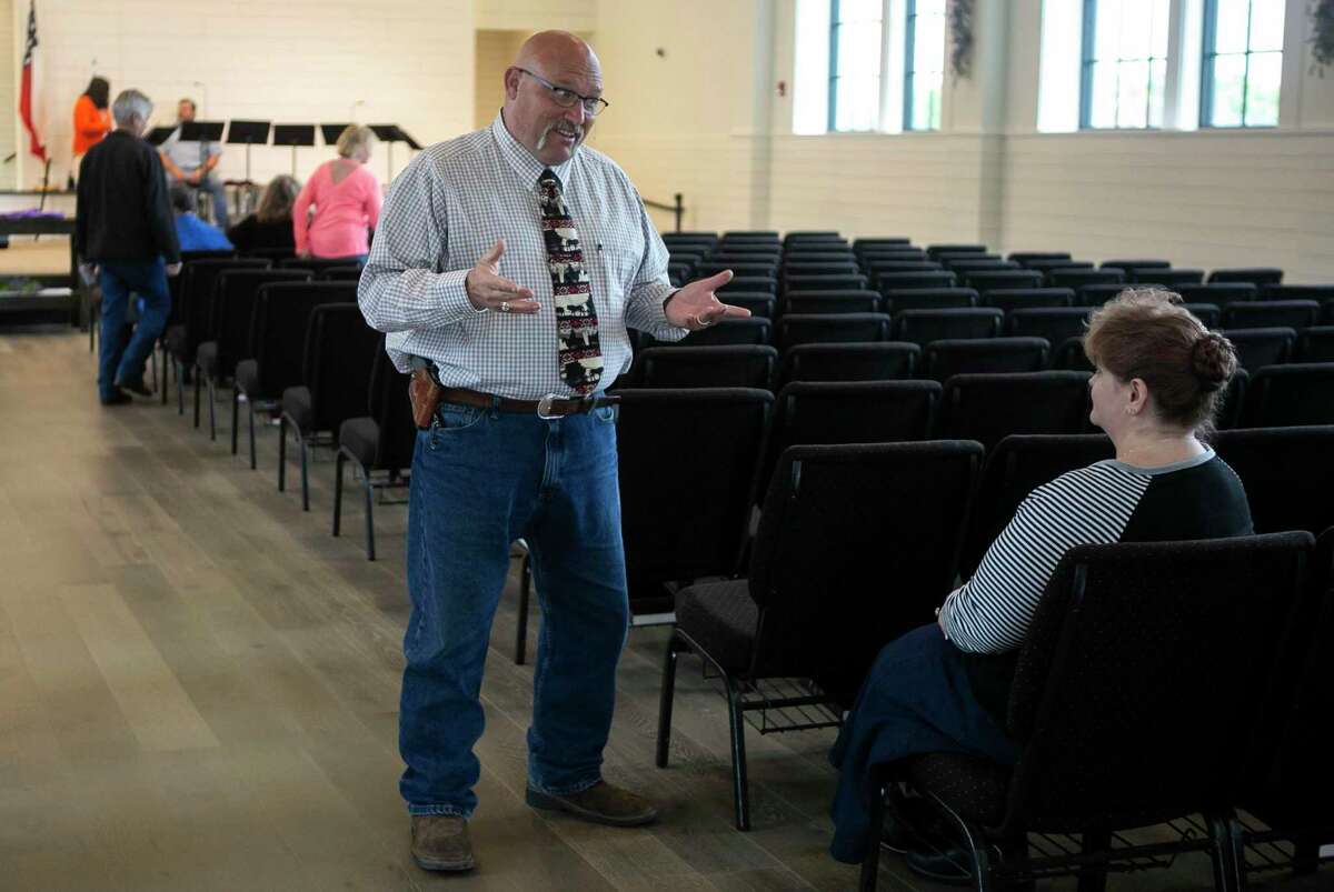 Pastor Frank Pomery talks with visitor Charlene Cummings before Sunday morning service at First Baptist Church in Sutherland Springs, Texas, April 5, 2020. Cummings is visiting First Baptist because her home church is closed due to COVID-19 and wanted to worship with other believers in-person. Going to church has been an important part of Cummings' life and healing from the trauma she has survived and the resulting PTSD. "Church is just as vital (to me) as it was before the virus," she says.