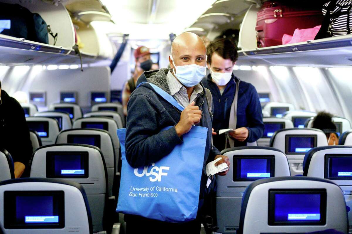 UCSF Dr. Sriram Shamasunder, co-founder of the HEAL Initiative, boards a flight at San Francisco International Airport while en route to Navajo Nation to treat COVID-19 patients on Wednesday, April 22, 2020. A group of UCSF staff including 14 nurses and seven doctors volunteered for the assignment in Navajo Nation hospitals in Arizona and New Mexico.