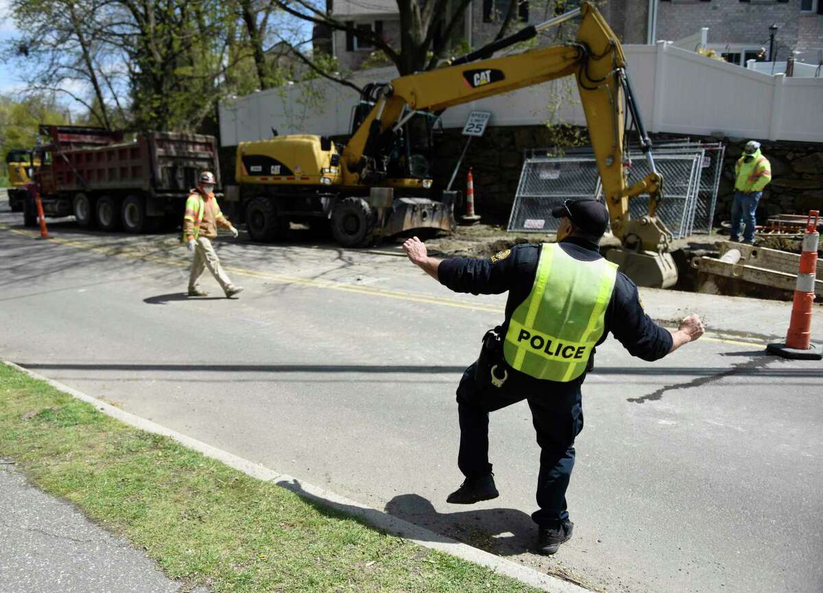 Greenwich Police Officer "Rockin'" Robert Smurlo dances while watching over construction near Bruce Park in Greenwich, Conn. Wednesday, April 22, 2020. Officer Smurlo has been dancing to music while directing traffic to put smiles on the faces of passers by.