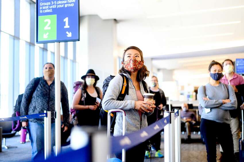 UCSF nurse Jamilah Dula and fellow UCSF health care workers board a United Airlines flight at San Francisco International Airport en route to Navajo Nation to help care for COVID-19 patients on Wednesday, April 22, 2020, in San Francisco. A group of UCSF staff including 14 nurses and seven doctors volunteered for the assignment in Navajo Nation hospitals in Arizona and New Mexico.