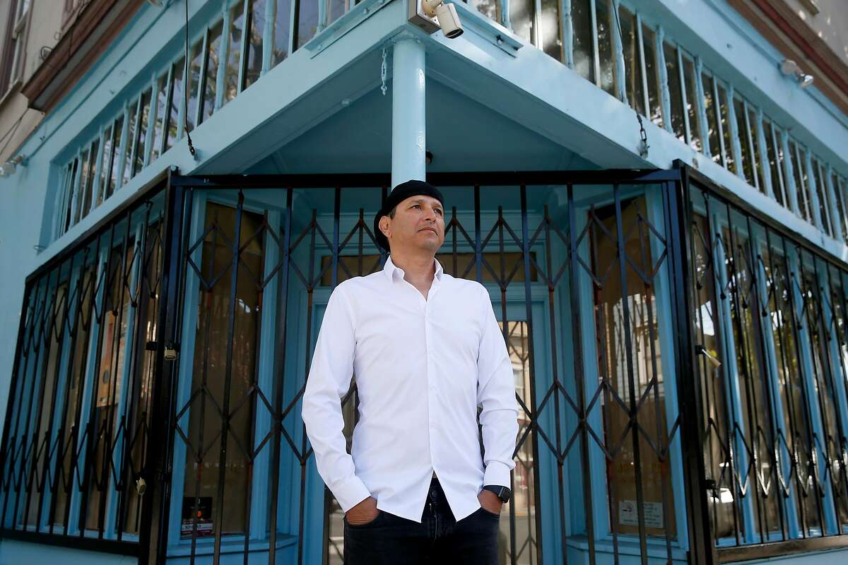 Mustapha Hakkou stands outside his Cafe du Soleil in the Lower Haight neighborhood at Fillmore and Waller streets in San Francisco, Calif. on Thursday, April 23, 2020. Hakkou was forced to shut down his cafe of 15 years after his landlord was unwilling to negotiate on a lower rent.