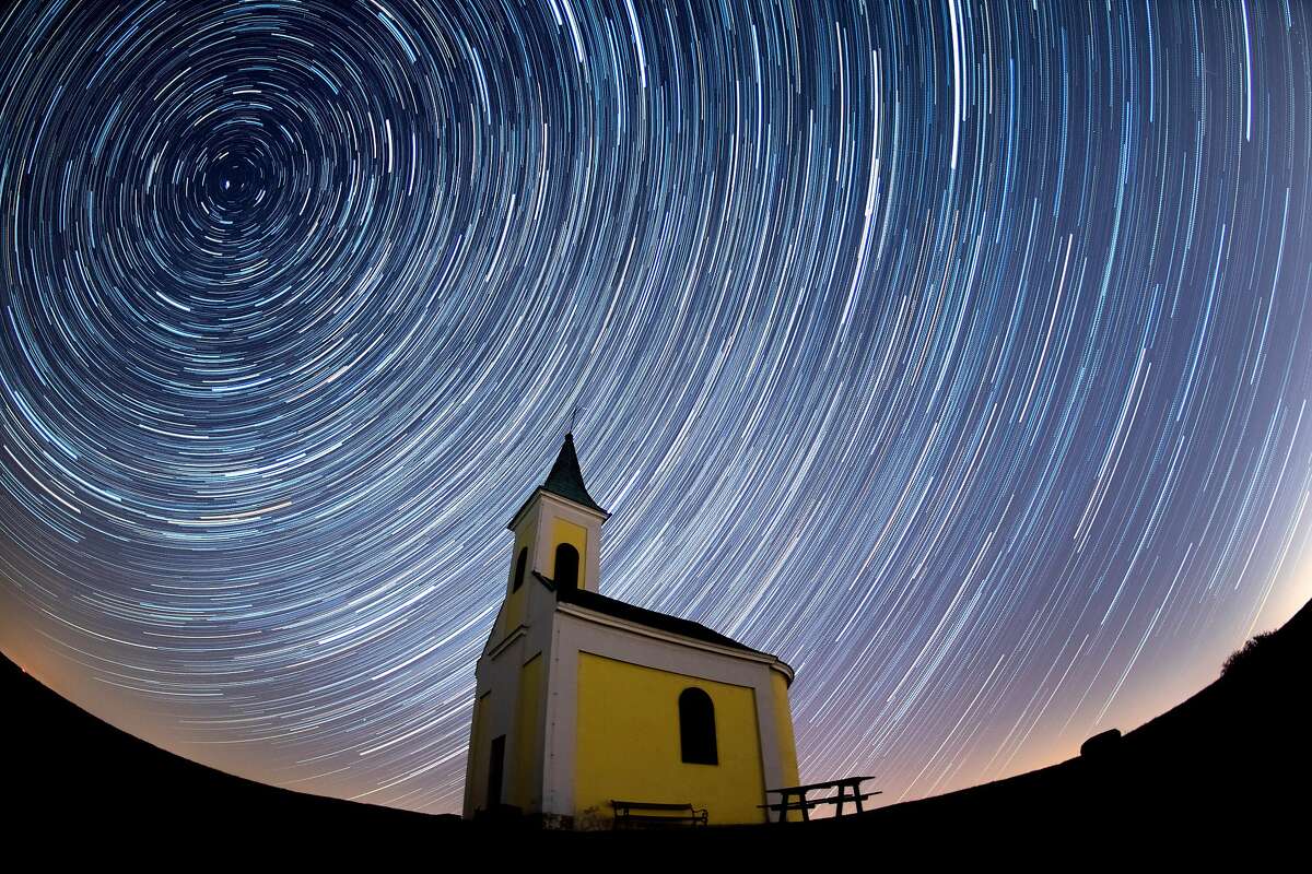 NIEDERHOLLABRUNN, AUSTRIA - APRIL 21: (EDITORS NOTE: Multiple exposures were combined to produce this image.) Startrails are seen during the Lyrids meteor shower over Michaelskapelle on April 21, 2020 in Niederhollabrunn, Austria. The clear skies created by the New Moon coincide with the Lyrid meteor shower, an annual display caused by the Earth passing through a cloud of debris from a comet called C/186 Thatcher. (Photo by Thomas Kronsteiner/Getty Images)