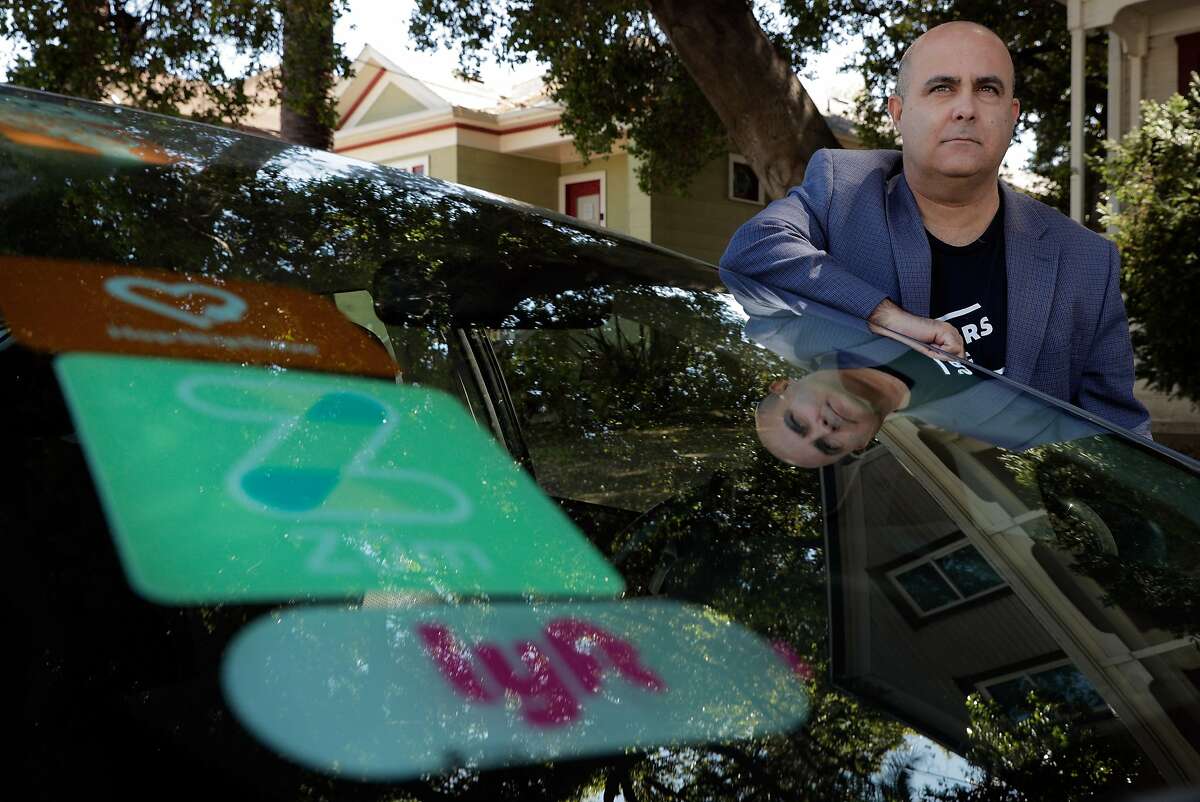 Lyft driver Edan Alva on the street where he lives in Alameda , Calif., on Wednesday, April 22, 2020. Alva was driving regularly for Lyft, Ziro, Zum and Hop Skip Drive before the Covid-19 pandemic stopped all services.