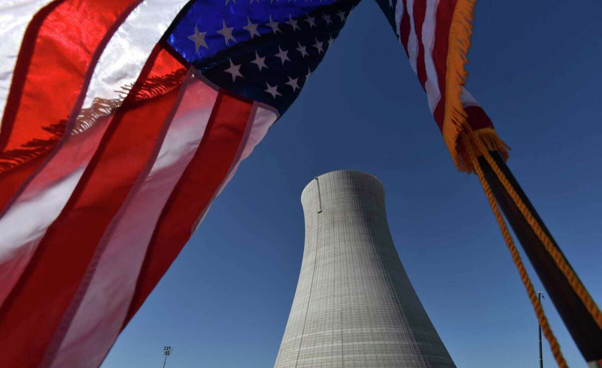 FILE - In this March 22, 2019, file photo an American flag flies on a construction site at Alvin W. Vogtle Electric Generating Plant, a nuclear power plant, in Waynesboro, Ga. The Trump administration on Thursday, April 23, 2020, urged government intervention to rescue U.S. uranium mining and nuclear fuel industries in a tough global marketplace, from making it easier to mine public lands out West to blocking some imports of foreign nuclear fuel. (Hyosub Shin/Atlanta Journal-Constitution via AP)