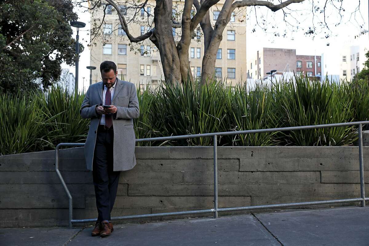 San Francisco District 6 Supervisor Matt Haney checks his phone while standing in Boeddeker Park, located at 246 Eddy Street, in San Francisco, Calif., on Friday, February 7, 2020. Since entering City Hall last year, Haney has quickly emerged as one of the most visible and active supervisors.
