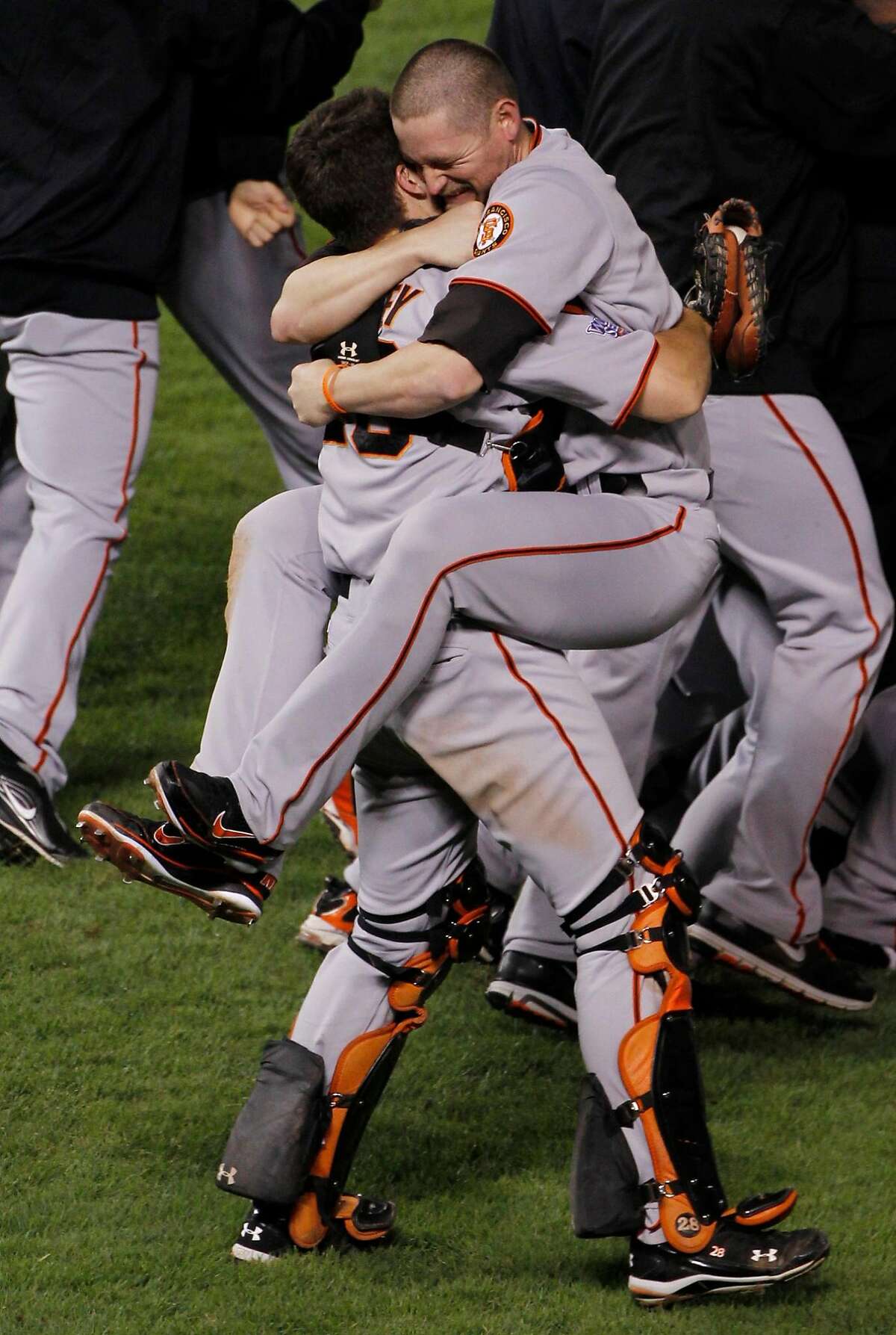 FILE - In this Nov. 1, 2010, file photo, San Francisco Giants Aubrey Huff hugs Buster Posey, left, after winning the World Series in Game 5 of baseball's World Series against the Texas Rangers in Arlington, Texas. How do the Giants find a way to win every other October. (AP Photo/Mark Humphrey, File)