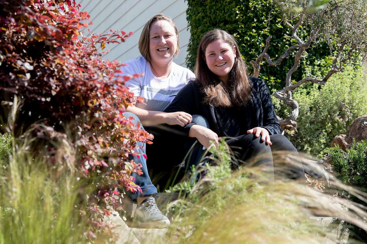 (From left) Jamie and Tarah Burns pose for a portrait outside of their home in San Francisco, Calif. Thursday, April 23, 2020. After years of waiting, they were scheduled to undergo fertility treatments to get pregnant this spring. But the coronavirus pandemic closed fertility clinics and has delayed their treatment indefinitely. They've gone from expecting to be pregnant in 6 weeks to not knowing when they'll be able to build their family.