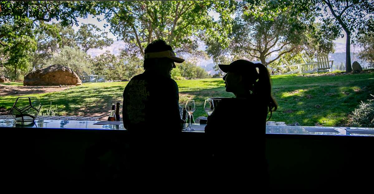 People have wine in the tasting room of Domaine Chandon in Yountville, Calif. on July 24th, 2018.
