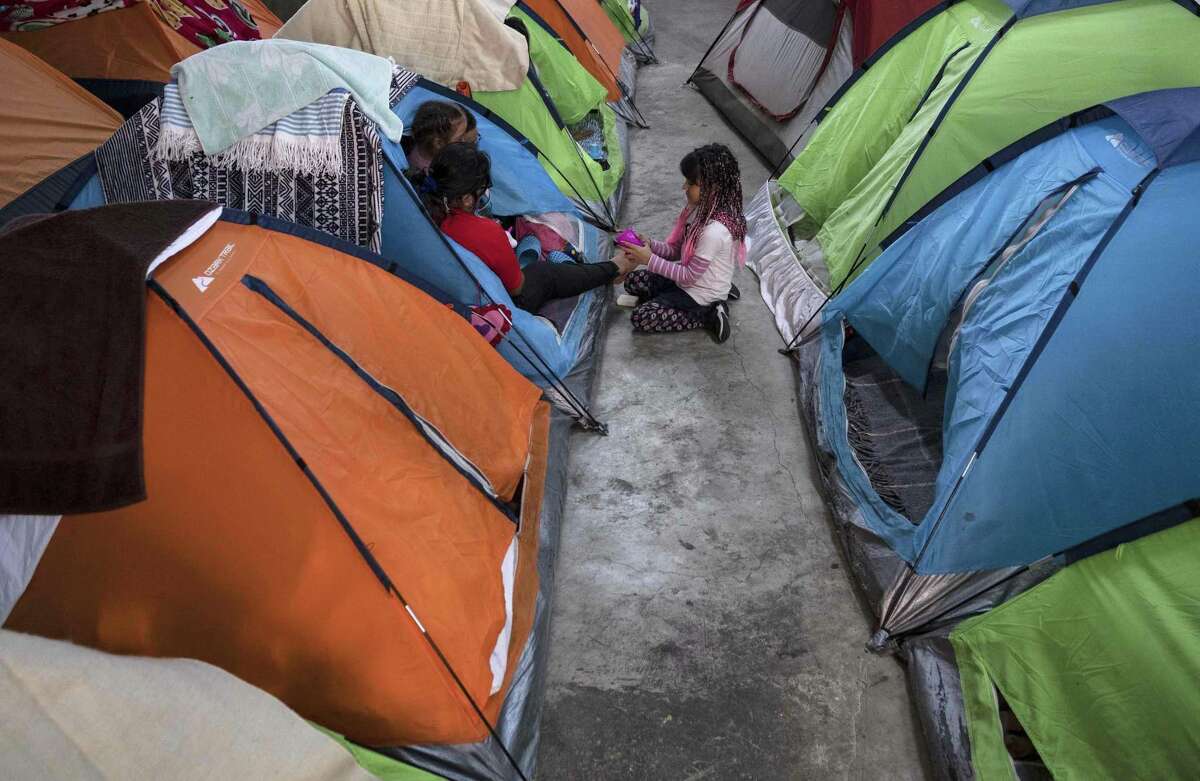 Members of an asylum-seeker family remain in a tent at the Juventud 2000 migrant shelter in Tijuana, Baja California State, Mexico, on April 3, 2020 during the novel coronavirus, COVID-19, pandemic. - Thousands of migrants overcrowding shelters or begging in the streets in Mexican cities along the US border are living in fear as the novel coronavirus spreads in the population and screening interviews for asylum seekers are being suspended. (Photo by Guillermo ARIAS / AFP) (Photo by GUILLERMO ARIAS/AFP via Getty Images)