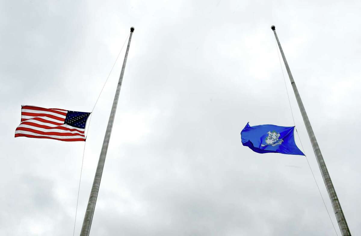 The U.S. flag and Connecticut flag fly at half staff.