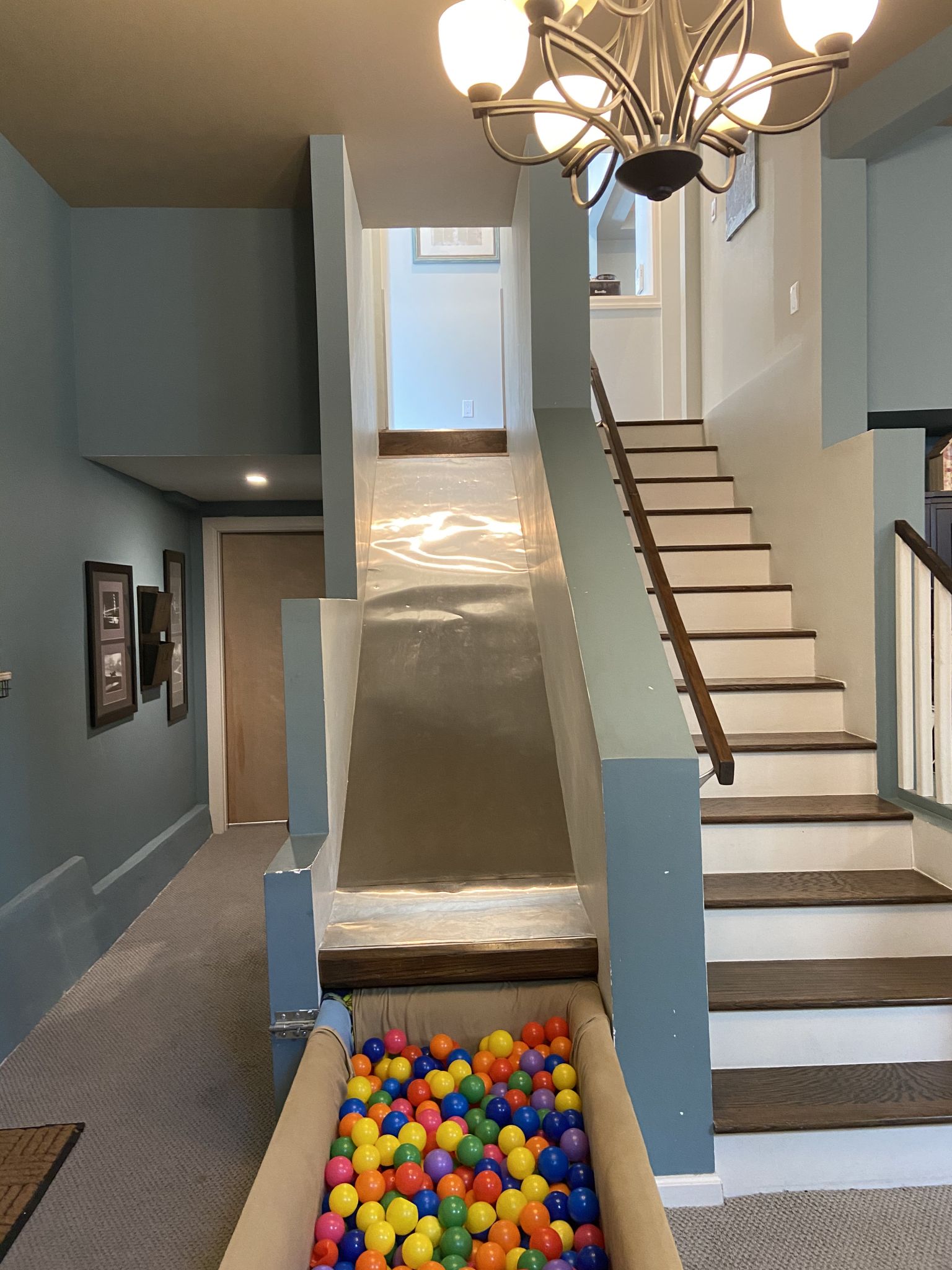 The slide runs into a ball pit that can be pushed away when not in use.