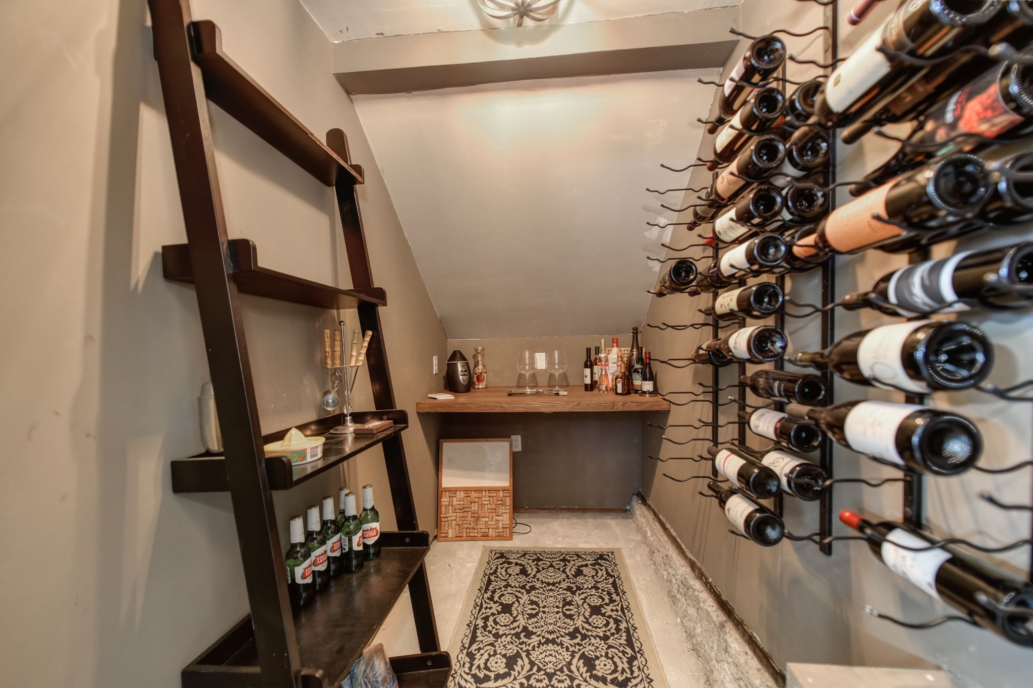 A wine cellar features a bar area for tastings and was built with mold-resistant sheet rock and has a fan for humidity control.