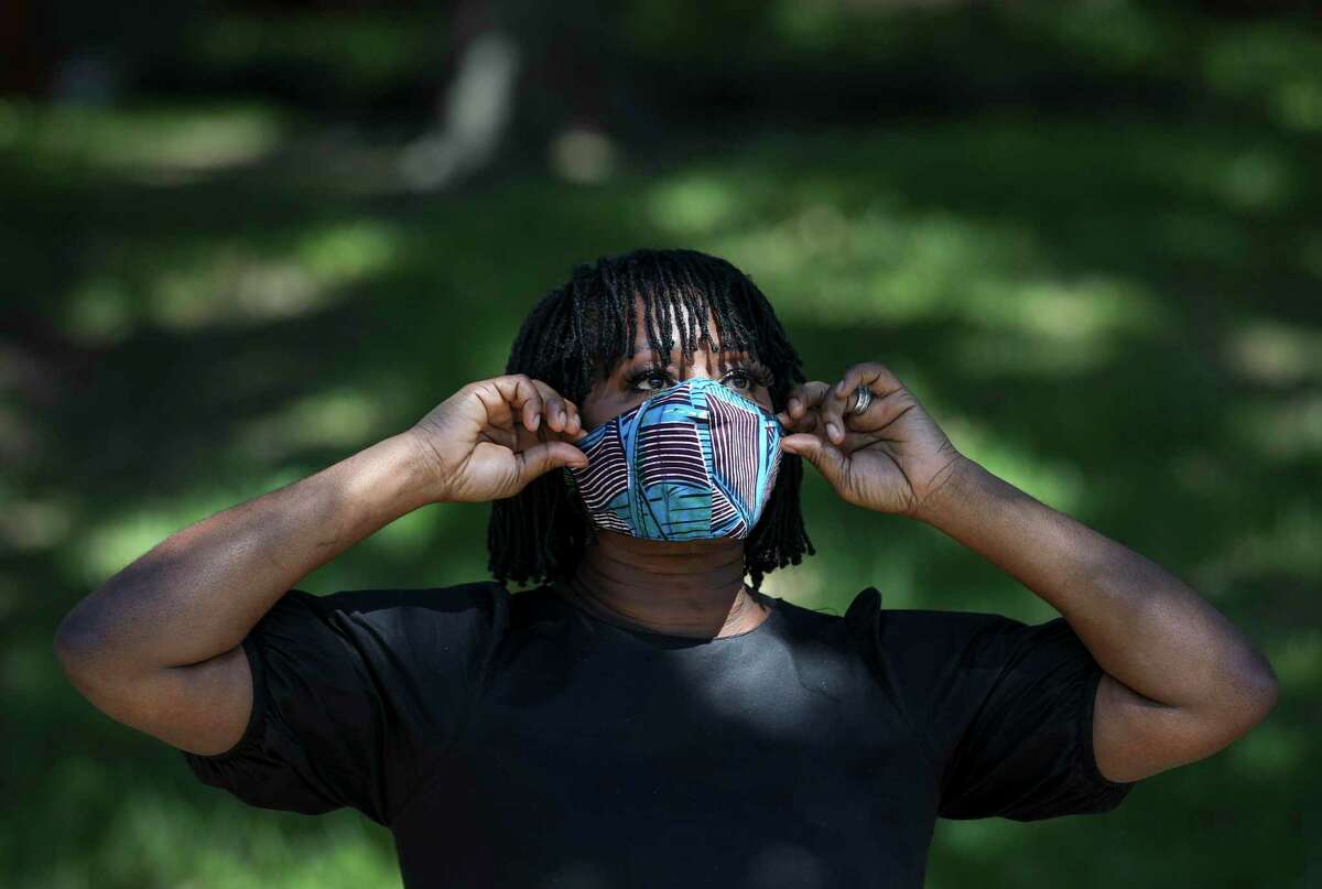 Onyii Brown, a designer, models a mask Thursday, April 23, 2020, at her home in Houston.