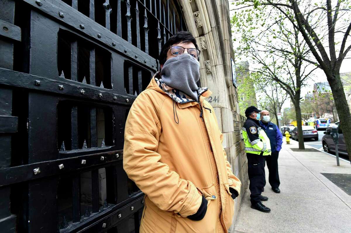 New Haven, Connecticut - Thursday , April 23, 2020: Not all students have left Yale University because of the Covid-19 / coronavirus pandemic. Here Aymane Eddahmany of Morocco, standing in front of Yale's Trumbull College. Eddahmany, a Fullbright Scholar and a Yale University Environmental Studies graduate student still lives on the Yale University Campus. International students who aren't able to go home, as well as students who can't go home because of various mitigating circumstance, are staying in Yale dorms, taking online classes.