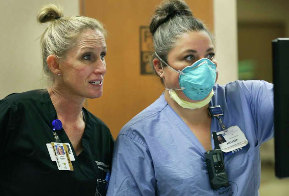 Dr. Tamara Simpson, left, checks a patient's stats with nurse Melissa Demarchi at Northeast Baptist Hospital COVID-19 unit on Friday, April 24, 2020. Simpson, with lines of her face from her mask, is a critical care pulmonologist who oversaw Nick's care while he was at Northeast Baptist. Photo: Bob Owen, San Antonio Express-News / ©2020 San Antonio Express-News