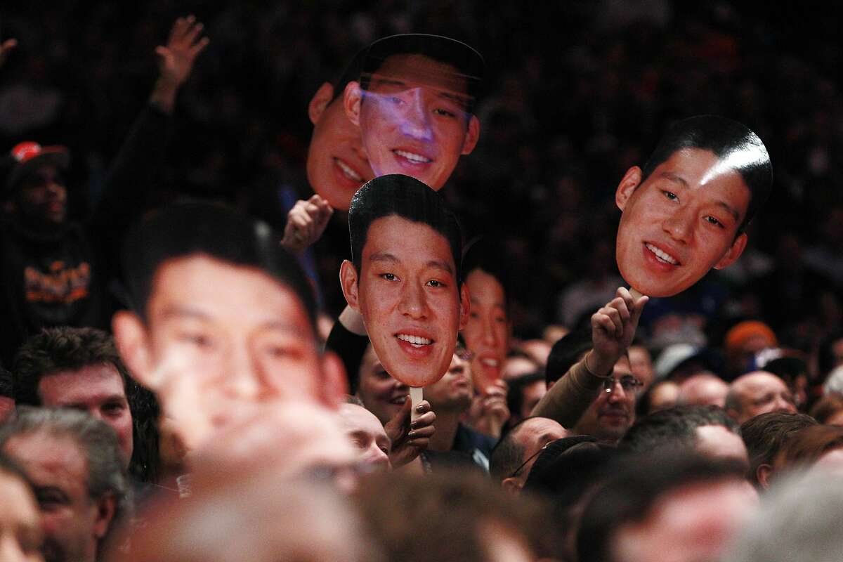 FILE - In this Feb. 15, 2012, file photo, fans hold up New York Knicks' Jeremy Lin photos during the second half of an NBA basketball game against Sacramento in New York. Linsanity is finally getting another run on MSG Network. In search of content to fill with no games because of the coronavirus, the network is turning to Jeremy Lin’s memorable NBA breakthrough, which was once ratings gold. The network said Friday, April 24, 2020 it will dedicate a week of programming to the 2012 stretch when Lin got his chance with the New York Knicks and took the league by storm.(AP Photo/Frank Franklin II, File)