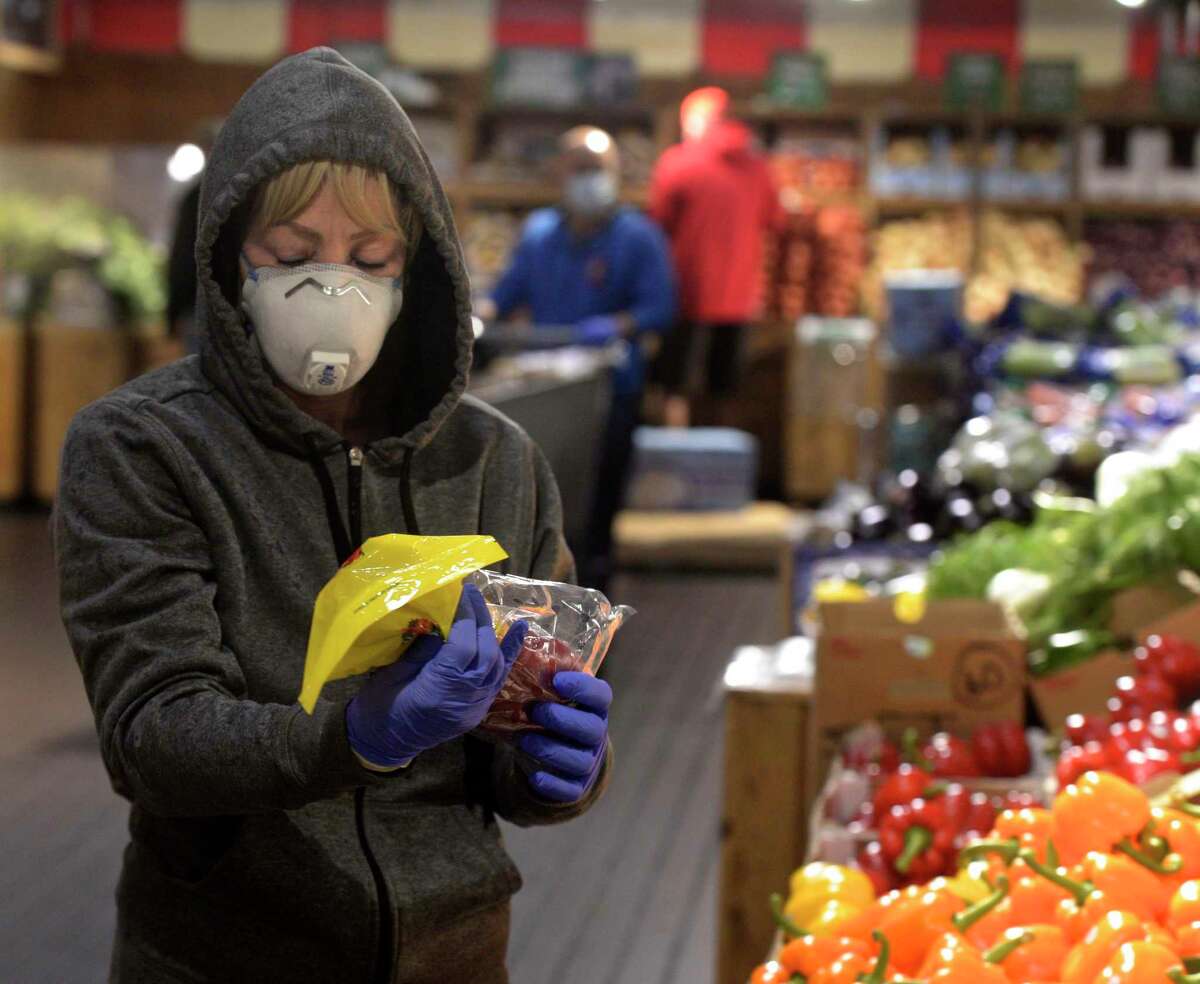 Jane Blackwell, of Brewster, NY, wears a mask while shopping at Stew Leonard's today, less than 24 hours after the implementation of Gov. Ned Lamont's order directing masks to be worn in public setting where social distancing is not possible. Danbury, Conn. Tuesday, April 21, 2020.