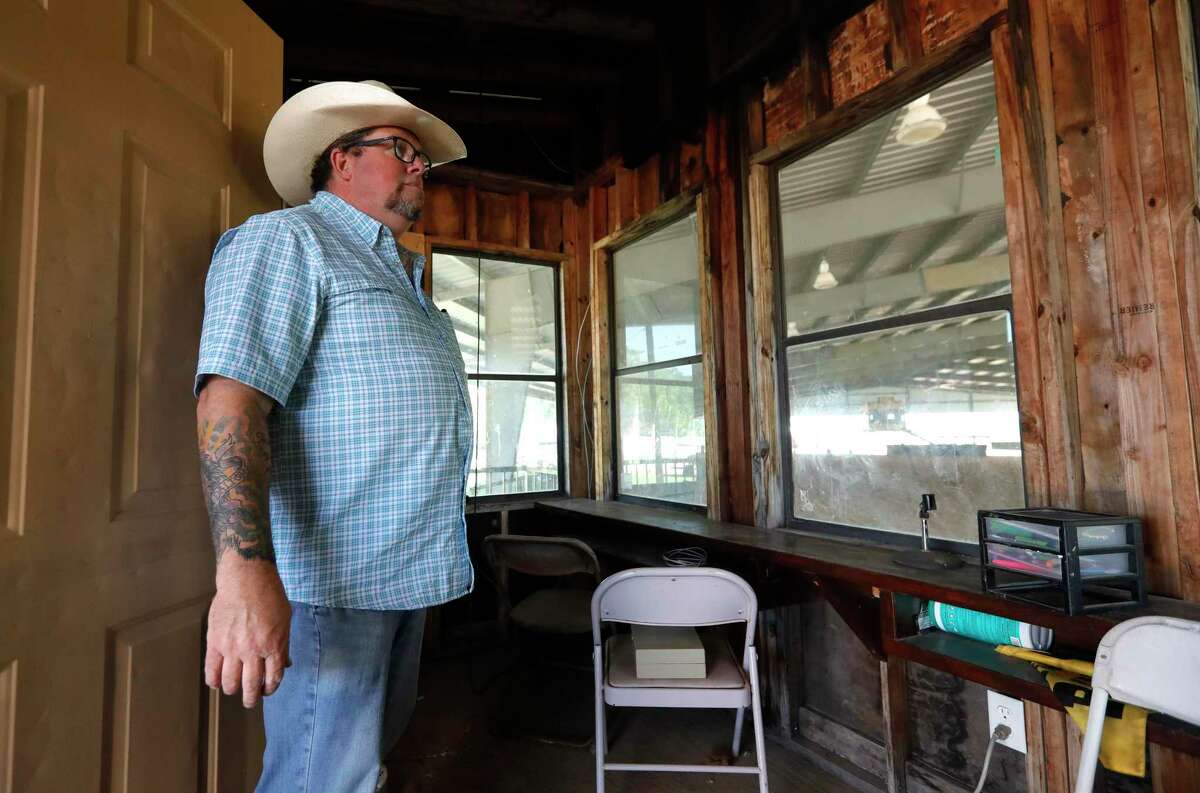 Pastor Mark Grimes looks over the empty rodeo arena booth at Caney Creek Cowboy Church after it was broken into, Friday, April 24, 2020, in Conroe. Thieves stole audio equipment from the booth, burglarized the organization’s office, van and attempted to steal heavy equipment last Sunday, April 19. Two other east county churches have also been burglarized since public health measures and restrictions were implemented in March.