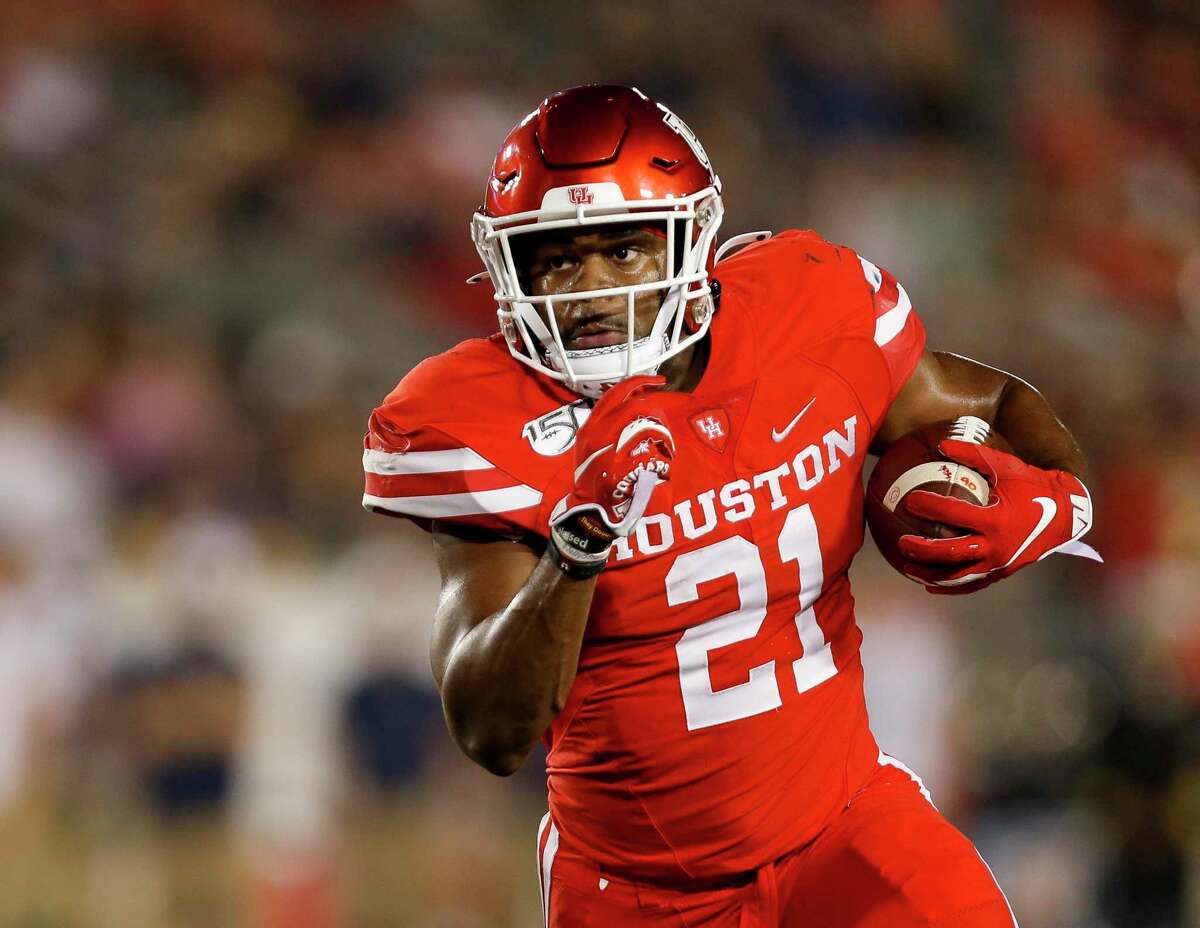 Houston Cougars running back Patrick Carr (21) scores a five-yard touchdown against the Navy Midshipmen during the first quarter of an NCAA game at TDECU Stadium Saturday, Nov. 30, 2019, in Houston.