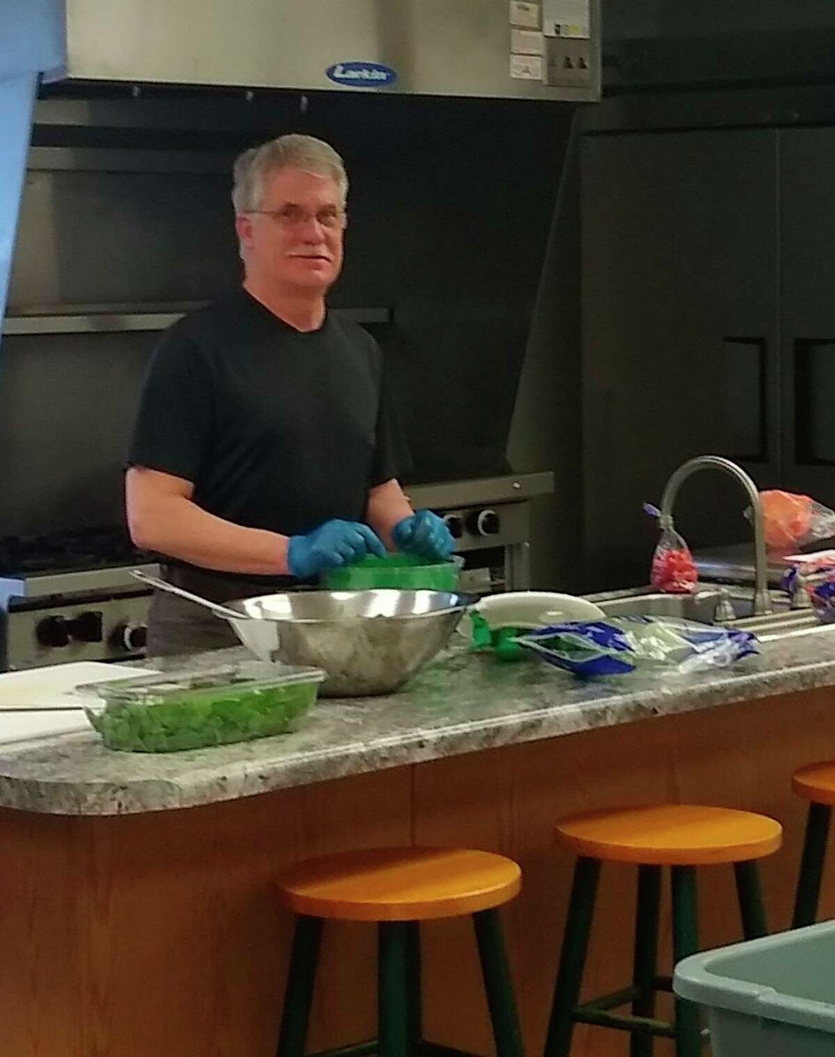 John Bennie, a staff member at New Journey Clubhouse in Big Rapids, helps prepare meals for clubhouse members during the extended "Stay Home Stay Safe" order from Gov. Gretchen Whitmer. Bennie also delivers meals and medications for members, and conducts well check ups while there, since the members can no longer come to the facility.  (Submitted photo)