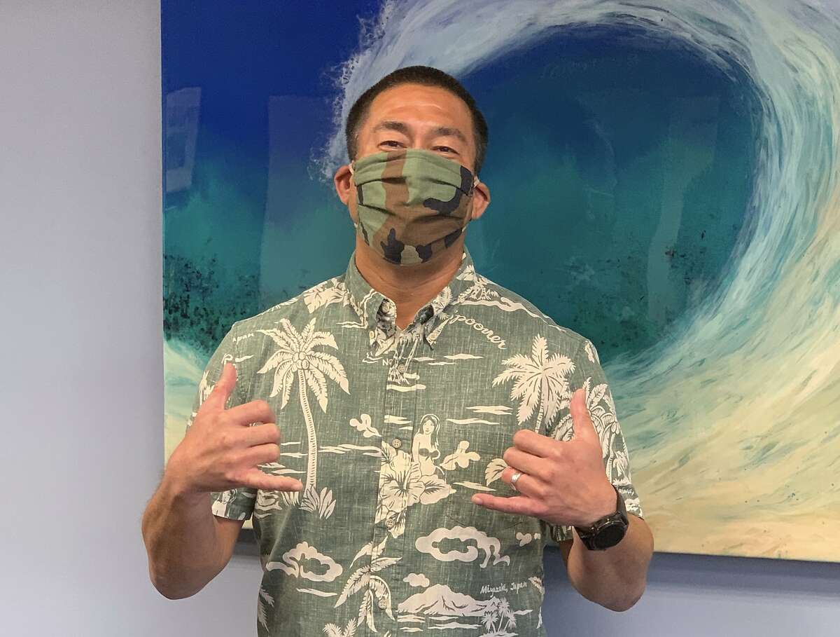 In this April 20, 2020, photo provided by the Kauai County, Hawaii, Kauai Mayor Derek Kawakami wears a mask in Lihue, Hawaii. Kawakami has imposed a curfew to curb the spread of the coronavirus and then entertains residents with nightly videos to "break the boredom." (Sarah Blane/Kauai County via AP)