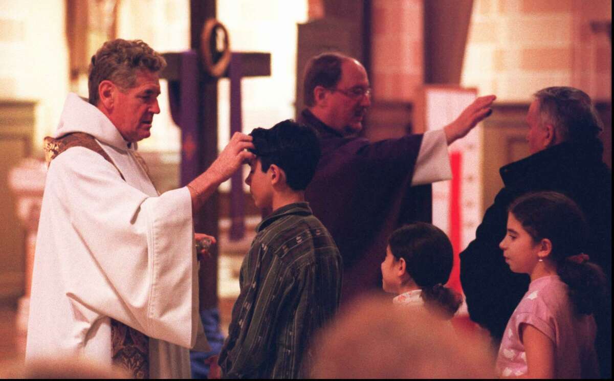 Ash Wednesday was celebrated by Catholics in the area with services and distribution of the ashes in 2001. At St. Cecilia’s Church on Newfield Avenue in Stamford the Rev. Roger Watts, left, the pastor, and the Rev. William Carey blessed the faithful.