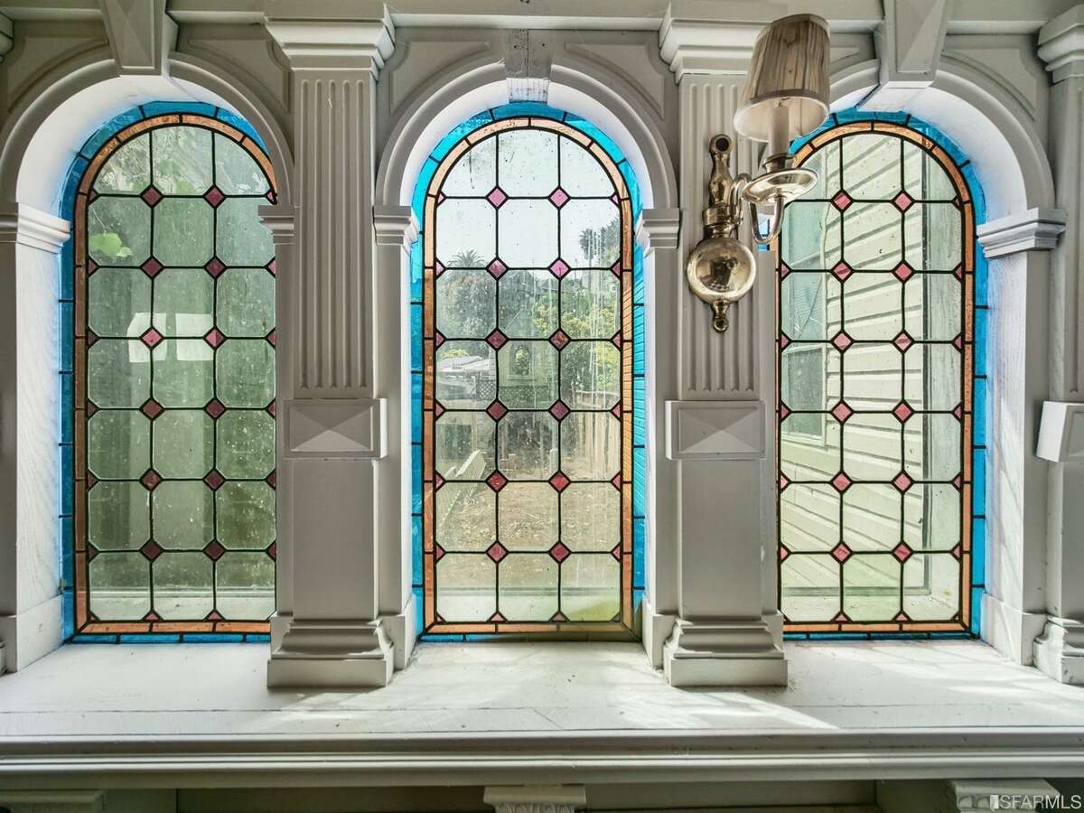 Arched stain glass windows at 253 States Street, built in 1902. The listing reveals that "the previous owner has been in the home for over 45 years and the home has very unique characteristics than can be leveraged."