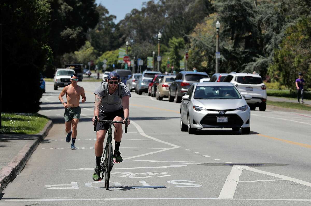Traffic of several kinds on John F. Kennedy Drive in Golden Gate Park in San Francisco, Calif., on Monday, April 27, 2020. City health officials extended the stay at home order until the end of May, and will be shutting down the street to vehicle traffic.