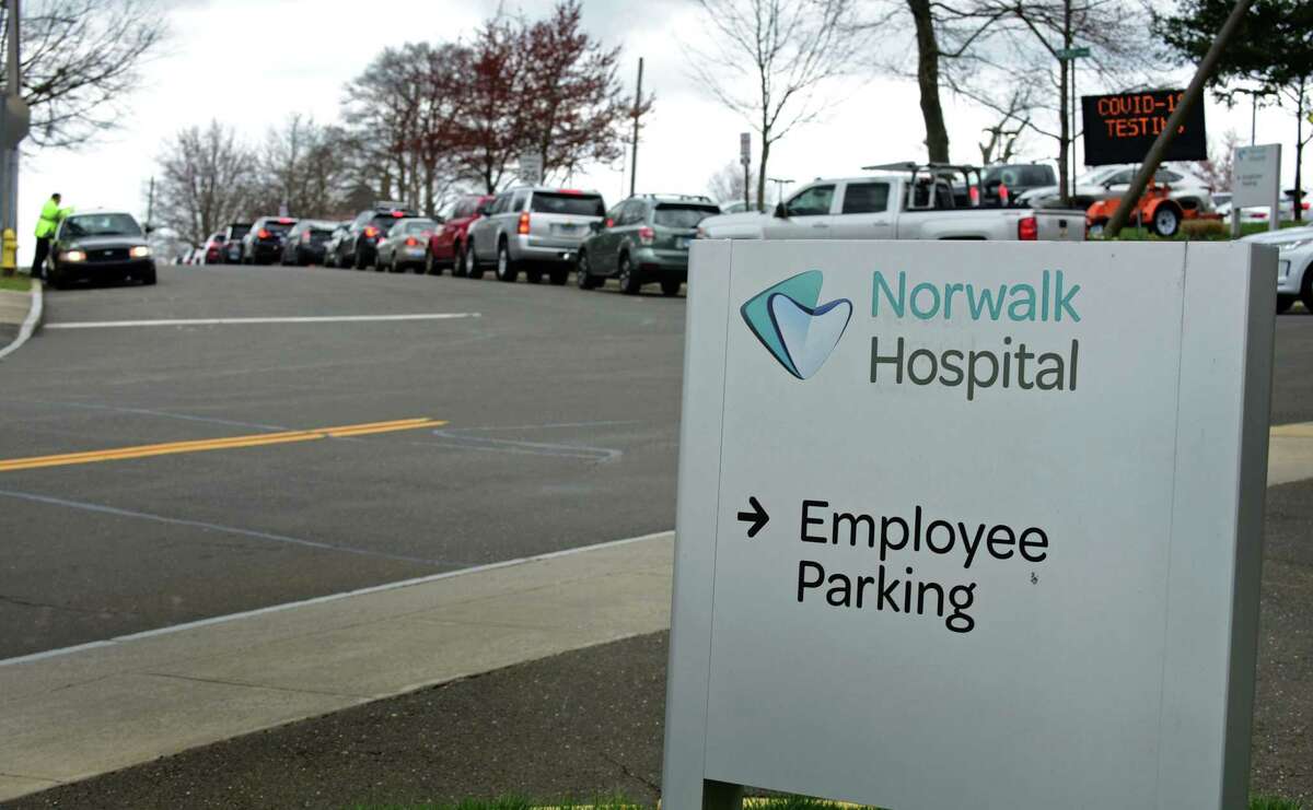 People wait inline for coronavirus testing at Norwalk Hospital Wednesday, April 8, 2020, in Norwalk, Conn.