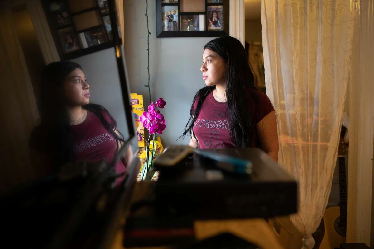 Undocumented immigrant Juana, 24, from El Salvador looks from her one-room apartment on March 25, 2020 in Norwalk, Connecticut. She lost her job as a house cleaner and her husband as a painter due to the coronavirus (COVID-19) pandemic. Undocumented immigrants cannot collect unemployment. Nor will they benefit from federal government bailout legislation.